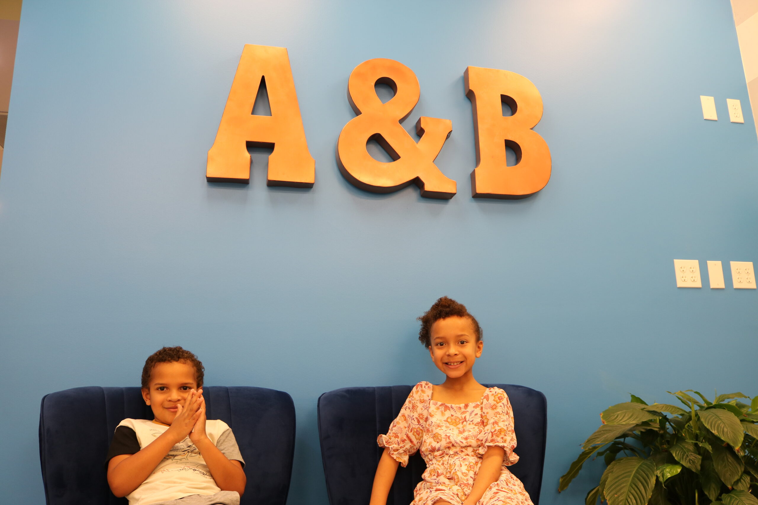 two children brother & sister smiling before their dental procedure